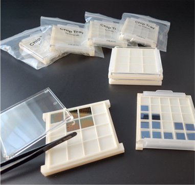 PYBLab chip trays with clear lids holding semiconductor dies, with tweezers and trays packed in zip bags