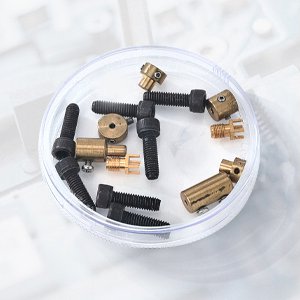 Transparent petri dish holding screws and brass parts
